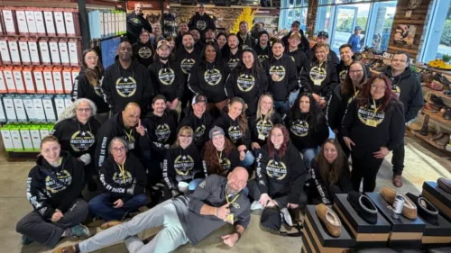 group photo of all the beck's shoes team leaders and upper management of beck's shoes, posing for a picture inside our santa cruz store