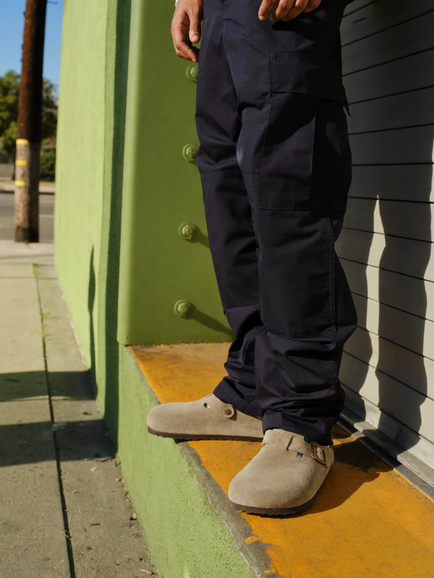 Person wearing Birkenstock Boston Taupe Suede clogs.