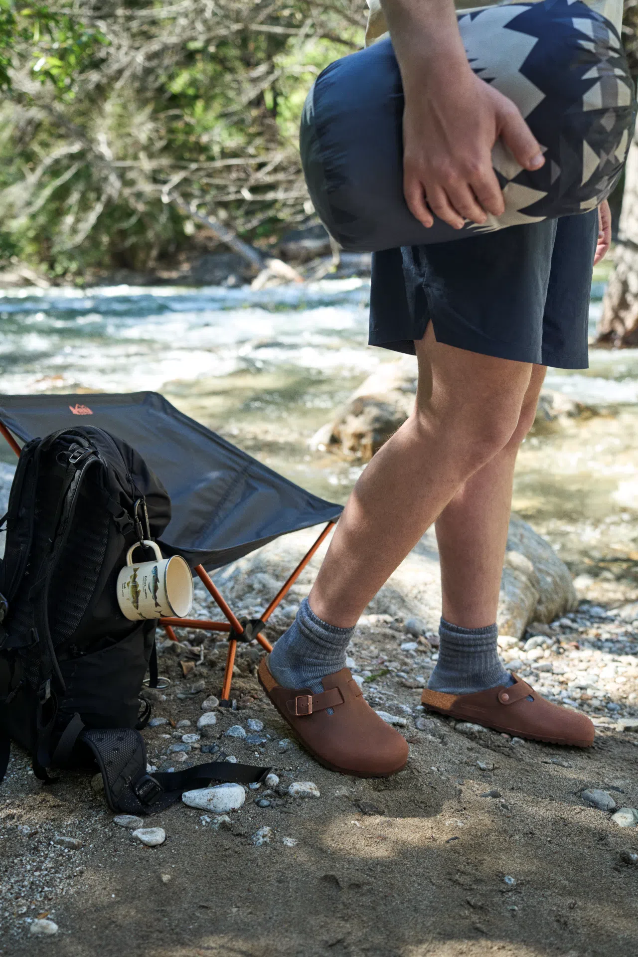 Person wearing Birkenstock Boston Habana Oiled Leather clogs outdoors.